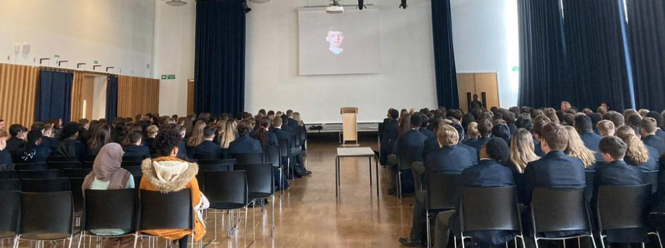 A school assembly in front of a projection