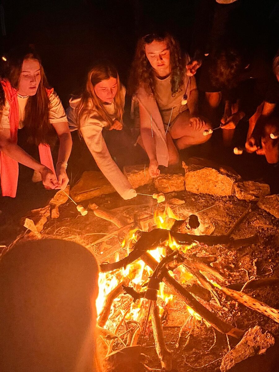 Students sat around a firepit