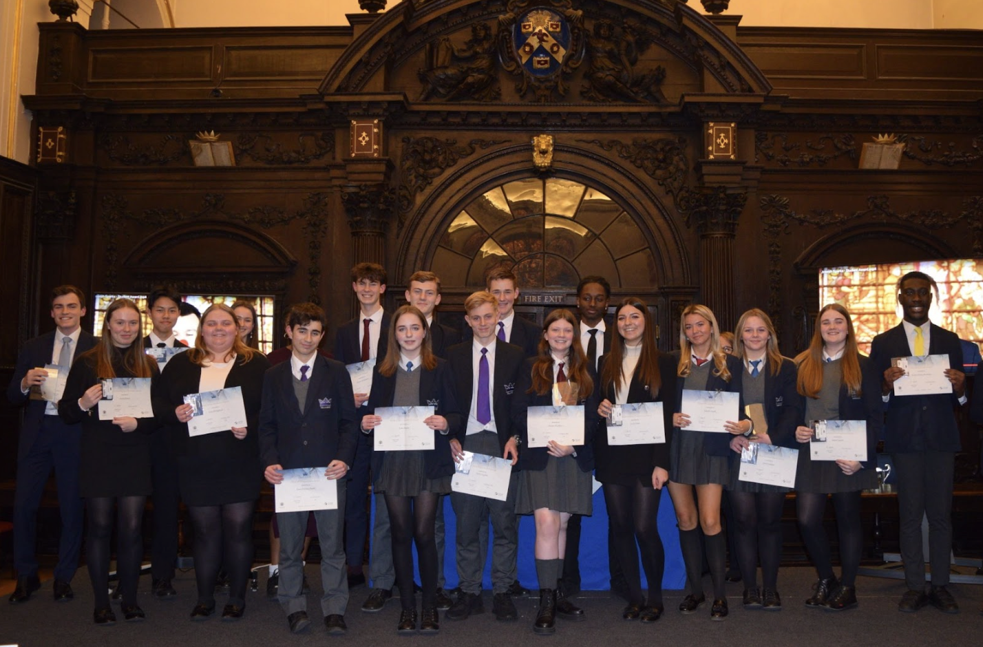 Students holding certificates of prize giving at Stationers' Hall, London
